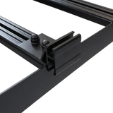 Close-up of a black metal frame with a Front Runner Series Slimsport Side Mount Accessory Bracket / Small, and two round black knobs on a white background.