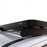 A close-up of a black Front Runner GWM Tank 300 (2023-Current) Slimline II Roof Rack Kit mounting system installed on a silver vehicle roof, with the brand name 'FRONT RUNNER' visible on the side.
