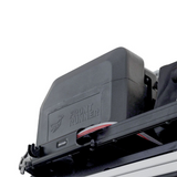 Close-up of a black Front Runner42L water tank and a Front Runner Tap Extension Bracket mounted on a vehicle roof rack, with the brand name embossed on the side.