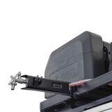 Front Runner 42L water tank with a Front Runner Tap Extension Bracket mounted on a black roof rack, shown against a white background.