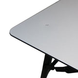 Close-up of a Front Runner Under Rack Table, table top corner with a black folding support leg visible against a white background.