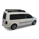 A white Volkswagen Caddy van with a black Front Runner Volkswagen Caddy LWB (2015-2020) Slimline II Roof Rack Kit, shown from a three-quarter rear angle on a clean white background.