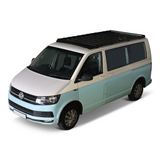 A light blue and white Volkswagen camper van with a black Front Runner Front Runner Volkswagen T5/T6/T6.1 Transporter SWB (2003-2024) Slimsport Roof Rack Kit, shown from a three-quarters front angle on a white background.