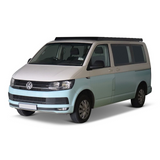 A Volkswagen Transporter van with a two-tone paint job of light blue and beige, featuring a black Front Runner Front Runner Volkswagen T5/T6/T6.1 Transporter SWB (2003-2024) Slimsport Roof Rack Kit, shown from a three-quarter front angle on a white background.