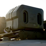 A Front Runner Pro Water Tank With Mounting System / 42L with a deer logo and the text 'FRONT RUNNER' mounted on a vehicle's roof rack.