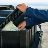 close up of Front Runner Wolf Pack Pro Ammo Box being opened on a roof rack by a person