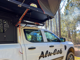 Alu-Cab MODCAP Family Tent Table Slide Fitted to an off-road vehicle in nature