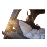Person lying in an Alu-Cab Gen3.R rooftop tent with a fitted Backrest accessory. camp 4x4