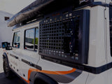 Alu-Cab INEOS Grenadier Exterior Molle Plate, mounted to a vehicle
