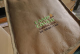 Beige ice maker cover with 'Camp Cover' logo and text on a blurred background