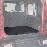 Red Suzuki Jimny with open door and the Front Runner Suzuki Jimny 5 Door Base Deck installed.