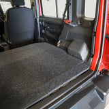 Red Suzuki Jimny with open door and the Front Runner Suzuki Jimny 5 Door Base Deck installed.