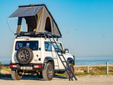 Alu-Cab Telescopic Ladder 2m for access into the Alu-Cab LT-50 lightweight Rooftop Tent mounted on a Suzuki Jimny at the beach 