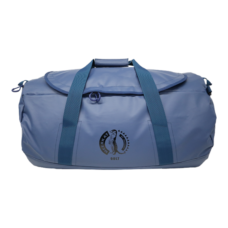 A blue 90 lt MEERKAT Travel Bag / duffel bag with dark blue webbing handles and a circular black logo on the front pocket, shown against a plain white background.