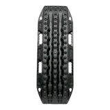 A black MAXTRAX LITE vehicle recovery track with deep grooves and circular tread patterns, shown vertically against a plain white background.