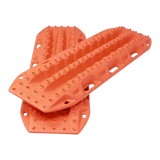Two bright orange MaxTrax MKII with deep tread grooves and mounting holes, shown overlapping on a plain white background.