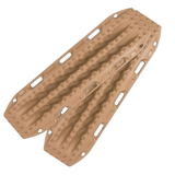 A pair of tan MaxTrax MKII with deep grooves and circular tread patterns, shown on a plain white background.