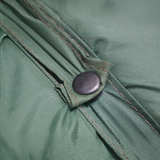 A close up view of a green MEERKAT Nylon Roll-Up Mattress, showing a clip and straps, displayed on a white backround