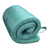 A side view of a green MEERKAT Nylon Roll-Up Mattress, Rolled up and  displayed on a white backround
