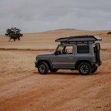 RoofPod Rooftop tent fitted to a Suzuki Jimny with a dry Desert background