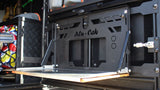 Alu-Cab Rear Door Drop Down Table, mounted to a camping vehicle