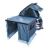 Car with a gray RoofPod rooftop tent and Awning attached on a white background