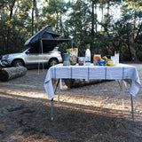 RoofPod Aluminum folding table set up at a camp site
