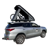 Silver SUV with a RoofPod SoloPod rooftop tent and bicycle on a white background