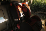 Child safety seat in a car with a blurred outdoor background