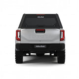 Rear view of the Alu-Cab Contour Canopy for the 2026+ Toyota Hilux Double Cab, mounted on the vehicle, on a white background