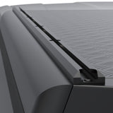 Close-up of a black Alu-Cab hardtop Canopy with a textured tread plate patterned roof panel and a black mounting track.