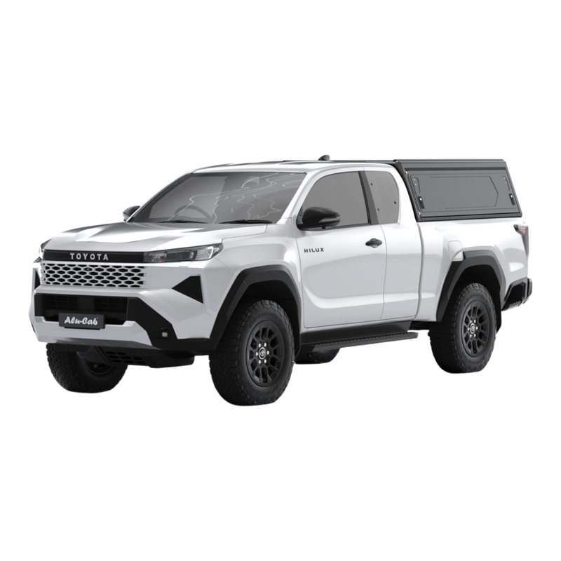 Main view of the Alu-Cab Contour Canopy, without side windows, for the 2026+ Toyota Hilux Extra Cab, mounted on the vehicle, on a white background