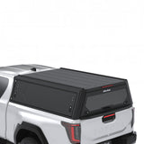 Arial view of the Alu-Cab Contour Canopy for the 2026+ Toyota Hilux Extra Cab, mounted on the vehicle, on a white background