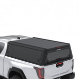 Arial view of the Alu-Cab Contour Canopy for the 2026+ Toyota Hilux Extra Cab, mounted on the vehicle, on a white background
