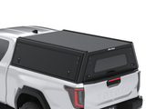 A white Toyota Hilux 2026+ Extra Cab with a Alu-Cab Explorer Canopy, with a smooth finish, over the bed, shown from a three-quarter rear angle on a white background.