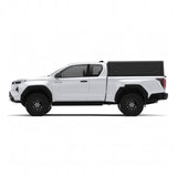 Side view of an Alu-Cab Explorer Canopy, with a tread plate finish, on a Toyota Hilux 2026+ Extra Cab on a white background.