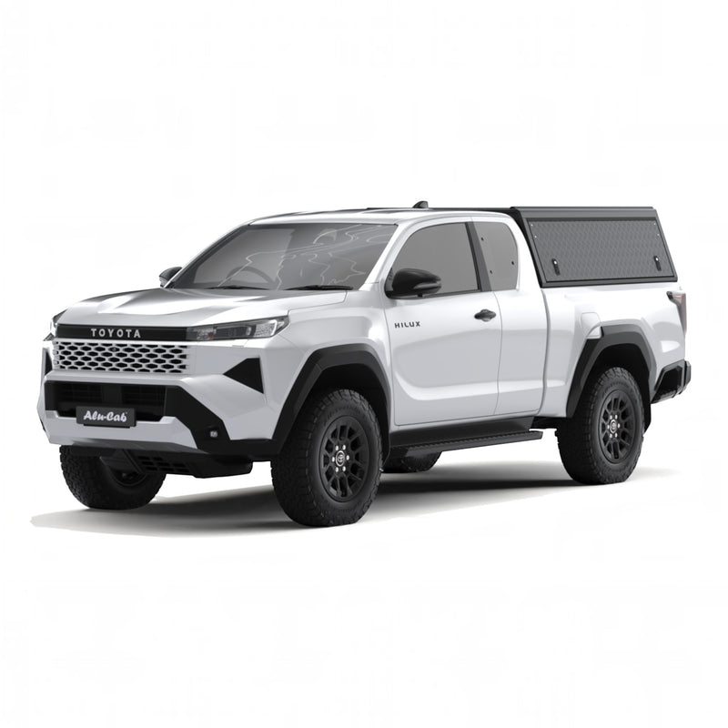 A white Toyota Hilux 2026+ Extra Cab with a Alu-Cab Explorer Canopy, with a smooth finish, over the bed, shown from a three-quarter front angle on a white background.