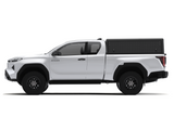 Side view of an Alu-Cab Explorer Canopy, with a tread plate finish, on a Toyota Hilux 2026+ Extra Cab on a white background.