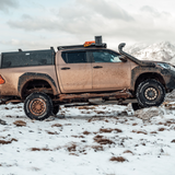 Muddy vehicle with Black Alu-Cab Explorer Canopy for double cab, with smooth finish. Camp4x4 camp 4x4, overlanding, camping