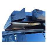 Alu-Cab Canopy Camper & Khaya Table Slide and Alu-Table mounted to an offroad Camper on a white background