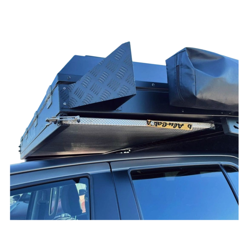 Alu-Cab Canopy Camper & Khaya Table Slide and Alu-Table mounted to an offroad Camper on a white background