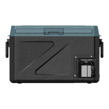 A portable Zalptic Z31 Camping Fridge Freezer with a dark teal lid, featuring a textured front panel with a large stylized 'Z' design, side handles, and a vented cooling fan on the lower right.