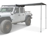 White Jeep with a Front Runner Roof Rack and extended Front Runner Awning