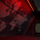 World map lit up on a Hardshell iKAMPER Skycamp 4.0 rooftop tent with a red glow, set against a starry night sky.
