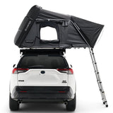 Black iKAMPER Skycamp 4.0 Trio, 3 sleeper, rooftop tent mounted on the roof of a white SUV, shown from the rear with the side ladder extended against a clean white background.