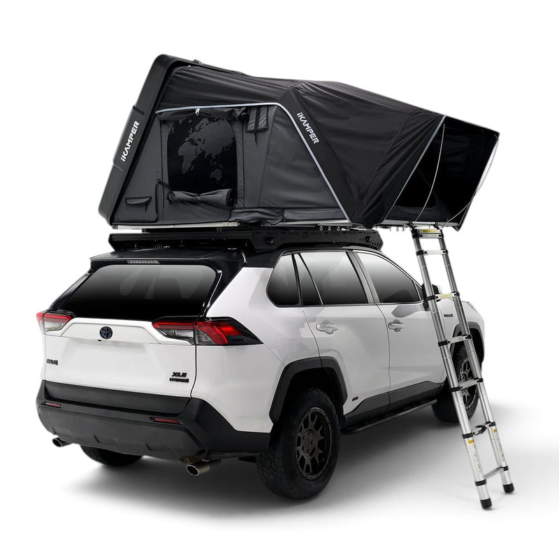 An iKAMPER Skycamp 4.0 Trio, 3 sleeper, rooftop tent mounted on a white SUV with a roof rack and ladder, shown on a clean white studio background. The tent has visible IKAMPER branding on the side panels.