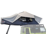 Front Runner Feather-Lite II Rooftop Tent attached to a vehicle on a white background. camping